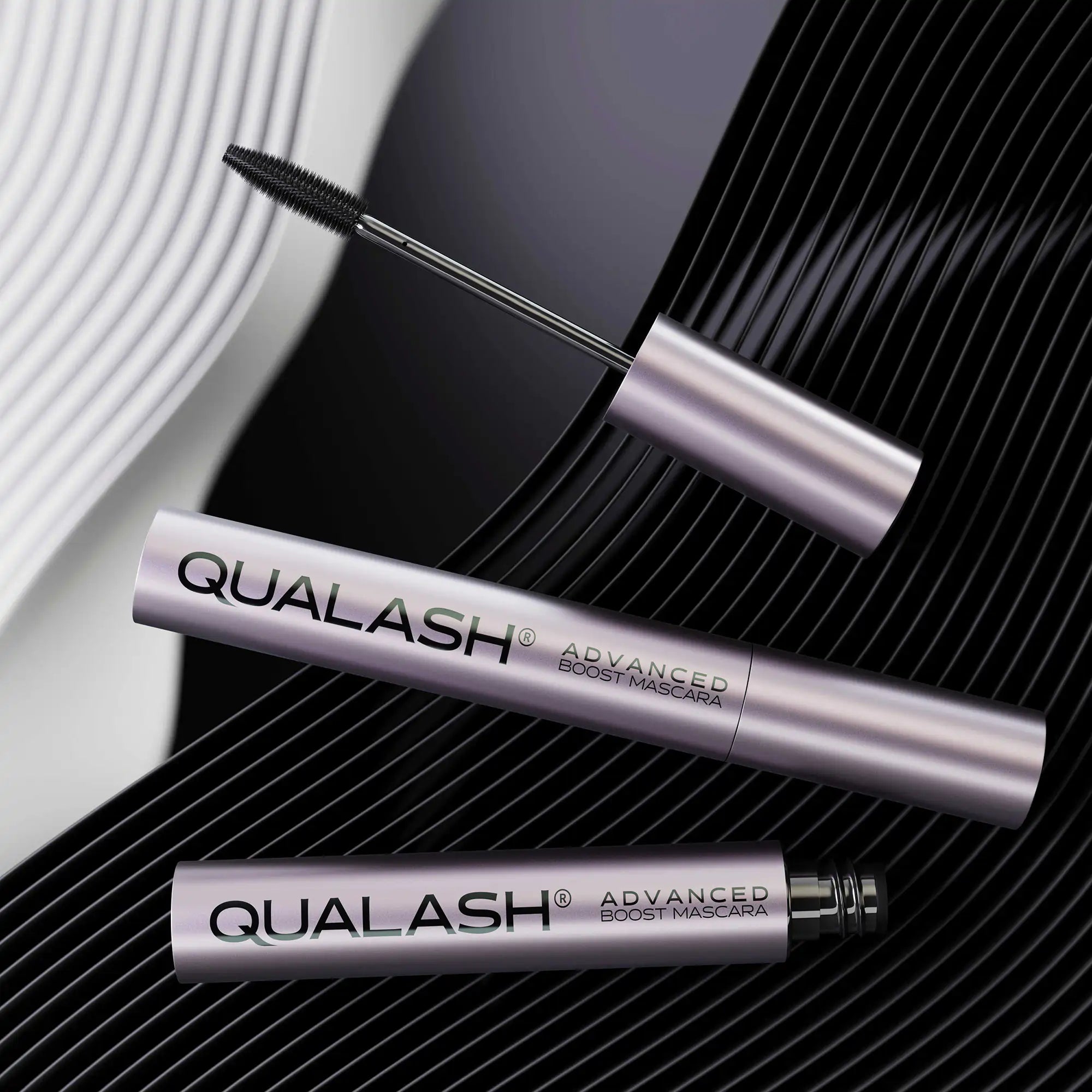 QUALASH Advanced Mascara Volume Max flatlay on dynamic black and white wavy background